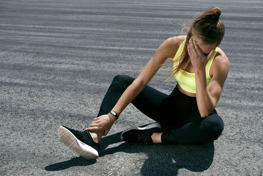 A woman on the ground with a stress fracture.