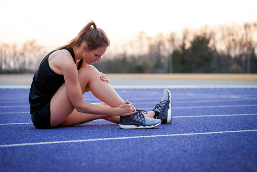 An injured woman holding her knee.