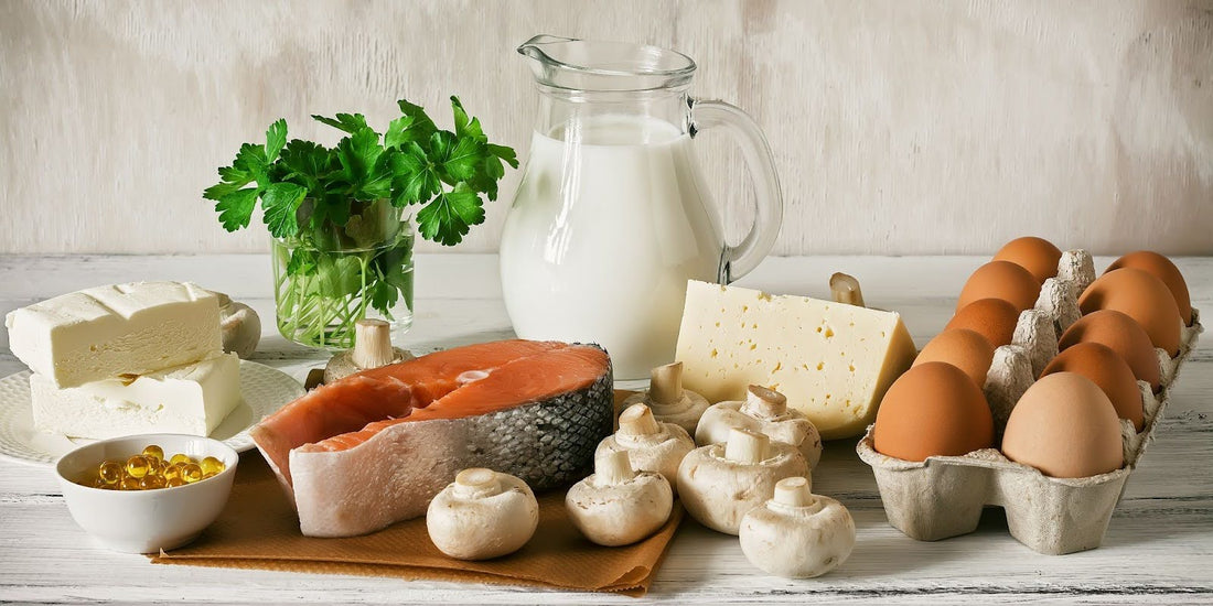 Milk, eggs, cheese, and bread on a table.